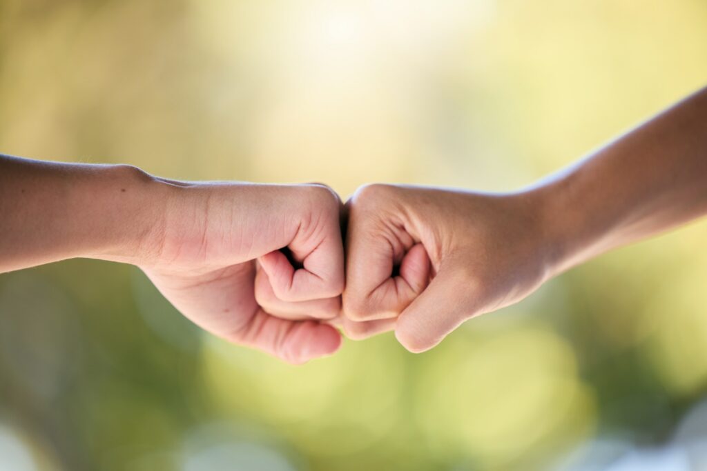 Fist bump, support and teamwork for collaboration, motivation or trust for project. Hands of friend